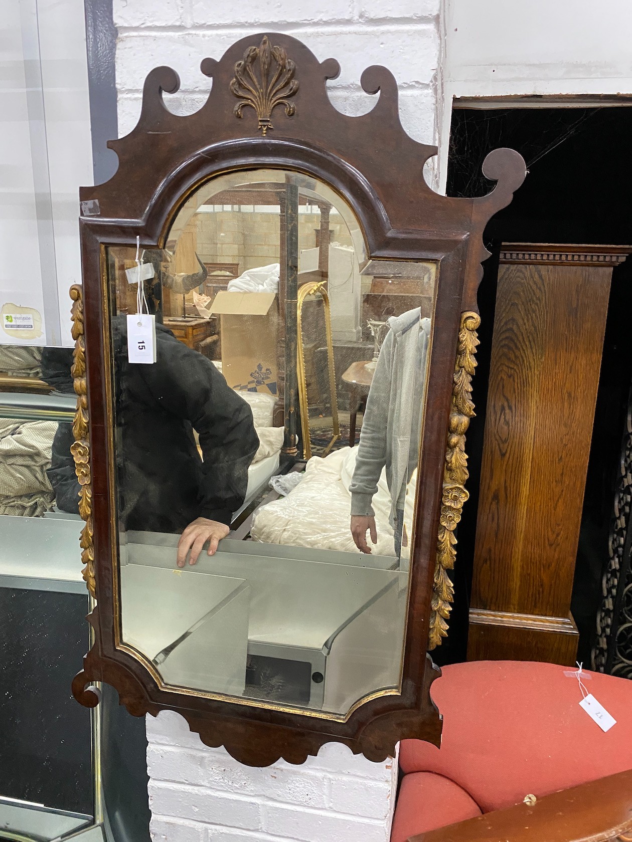 An early 20th century George III style parcel gilt fret cut mahogany mirror (a.f.), width 60cm, height 112cm